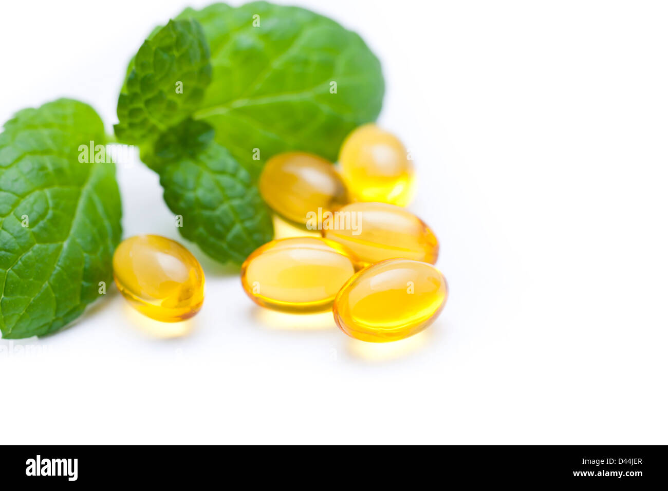 Gel vitamin capsules with mint leaf Stock Photo Alamy