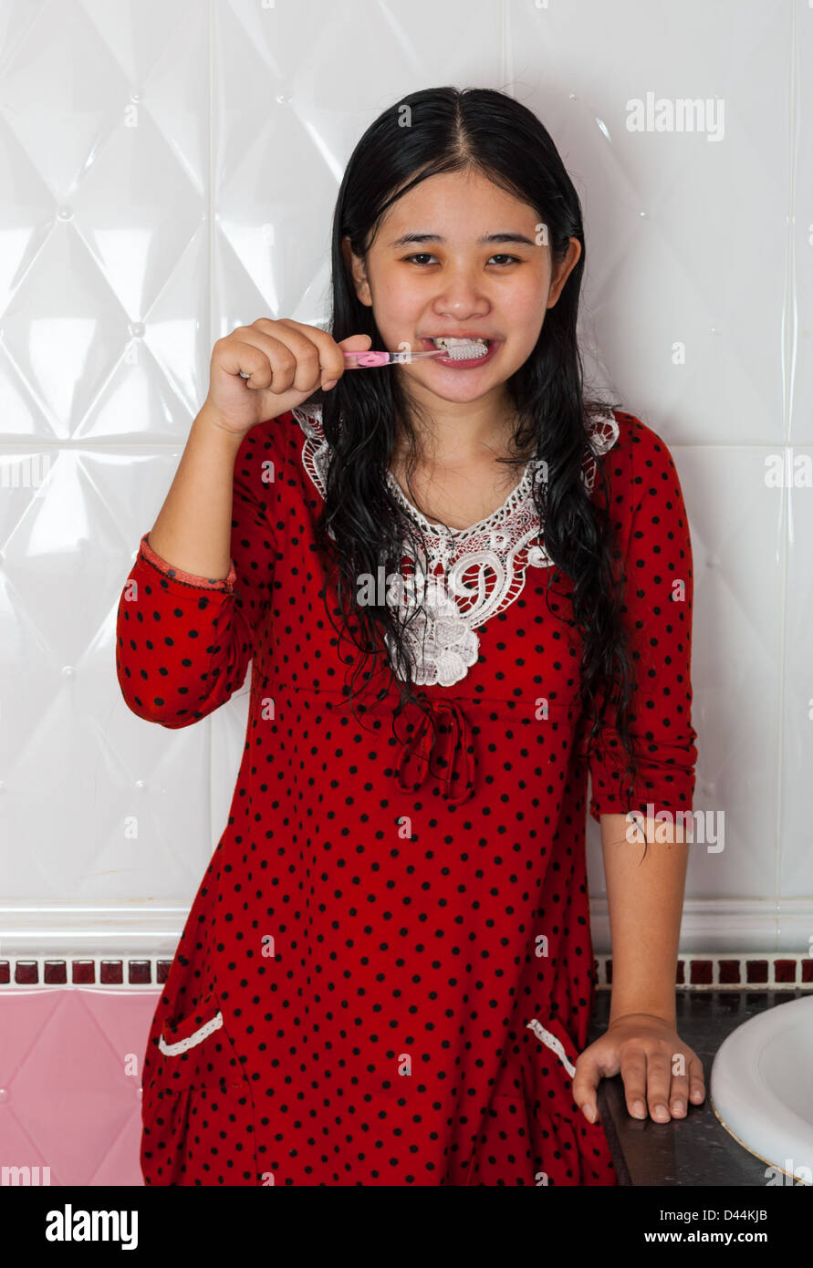 Cute Asian-Thai Girl is brushing her teeth Stock Photo