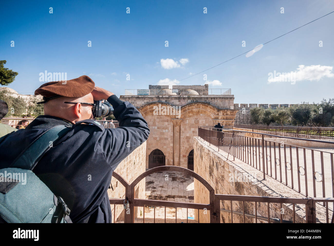 Temple Mount, Jerusalem. An officer, wearing the brown beret of the Golani brigade, takes a picture of the Golden (Mercy) gate. Stock Photo
