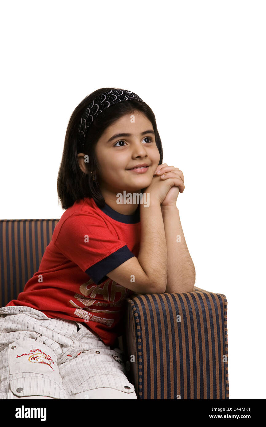 Girl sitting on a sofa Stock Photo - Alamy