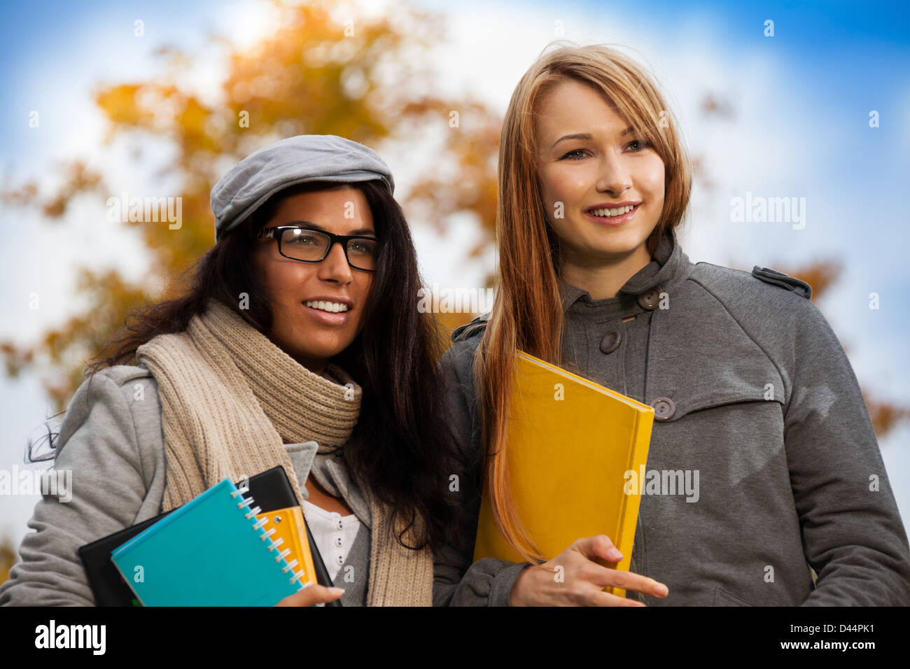 two happy girls with books in park Stock Photo - Alamy