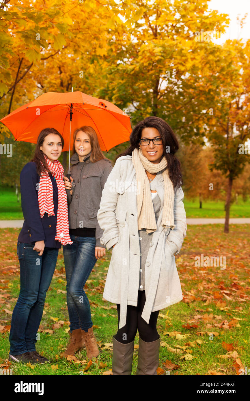 Happy girls walking in autumn park Stock Photo - Alamy