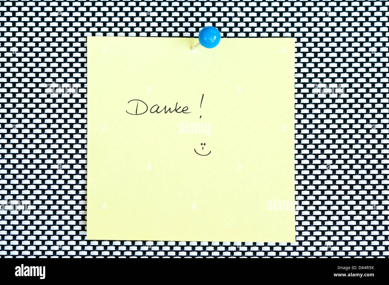 Postit note saying Danke arranged on black and white background Stock Photo