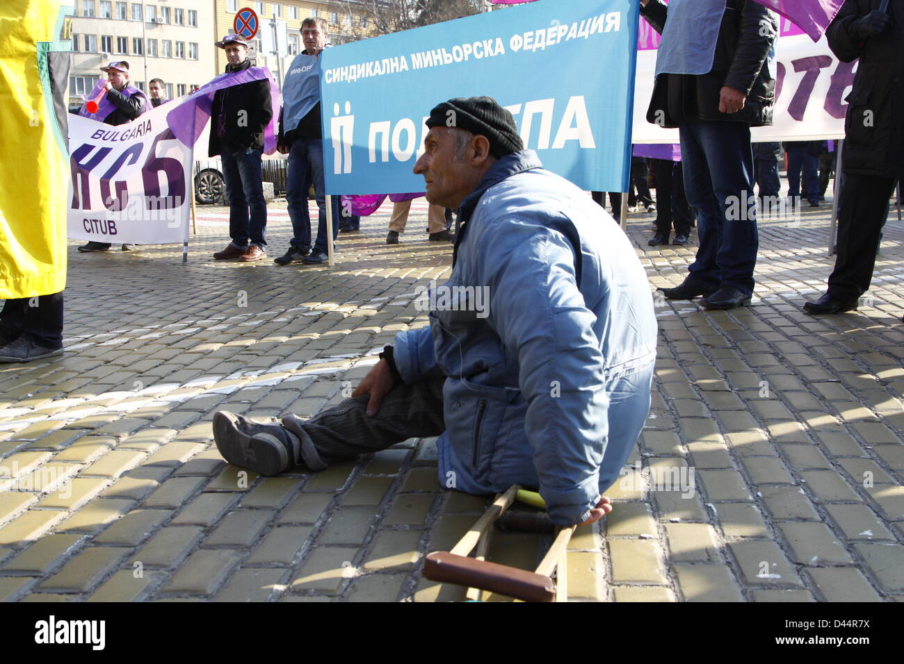 Sofia, Bulgaria; 05/03/2013. One-legged demonstrator sitting on the street in front of more than a thousand protesting fellow miners. (Credit: Credit:  Johann Brandstatter / Alamy Live News) Stock Photo