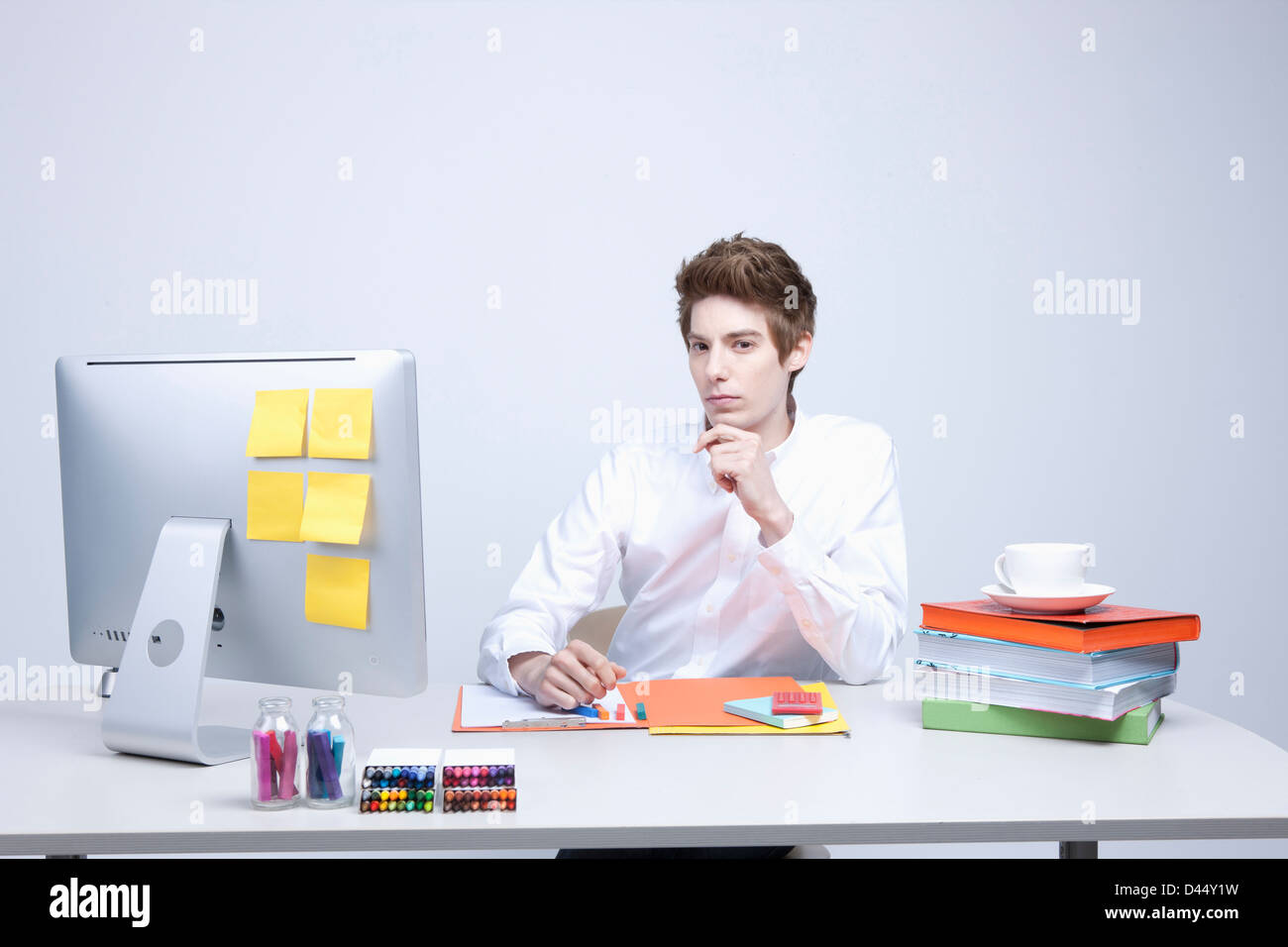 a man on a desk using computer Stock Photo - Alamy