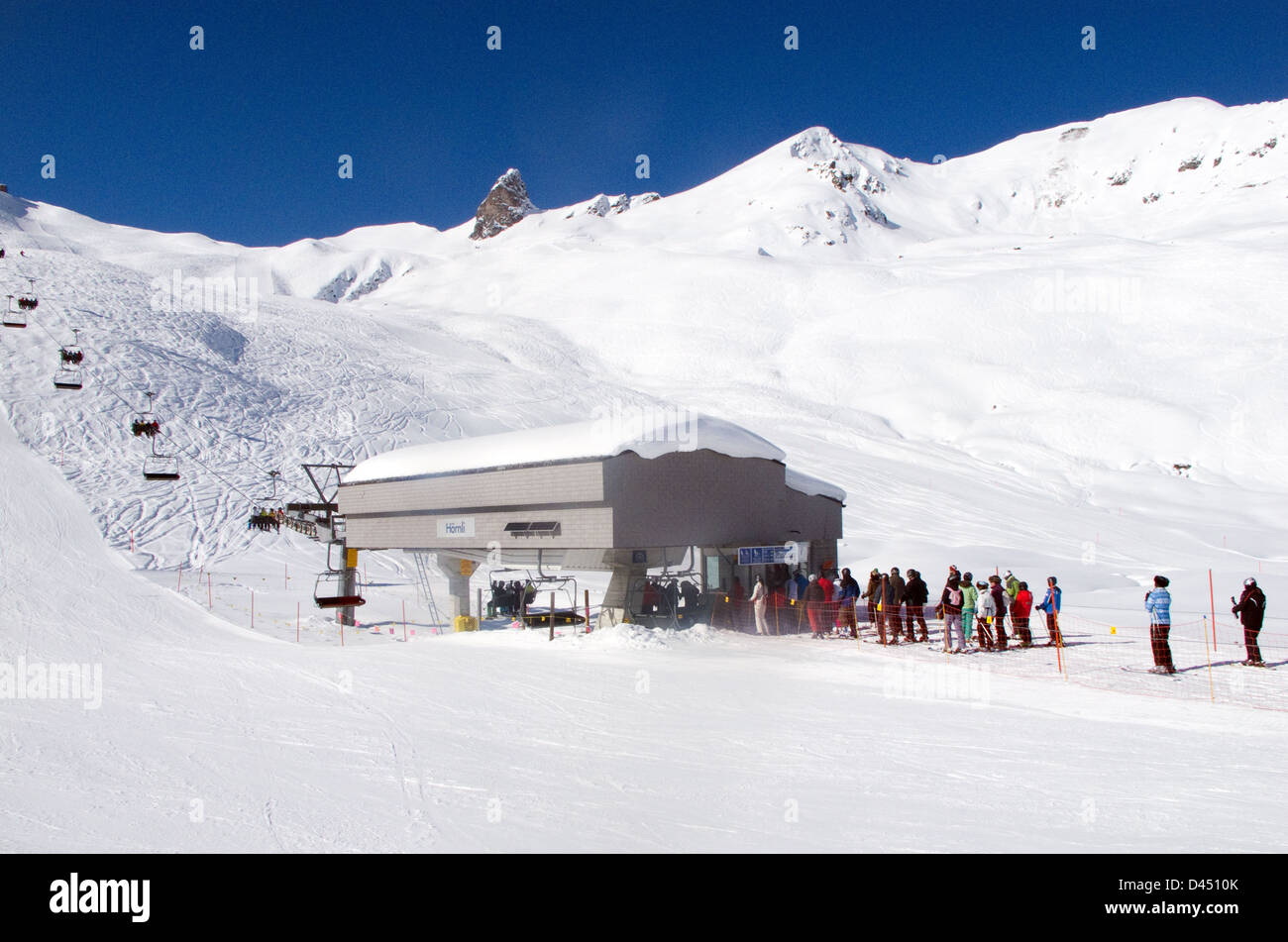 Skiers queuing for the Hornli ski lift on the slopes, to go skiing, Arosa, Switzerland Europe Stock Photo