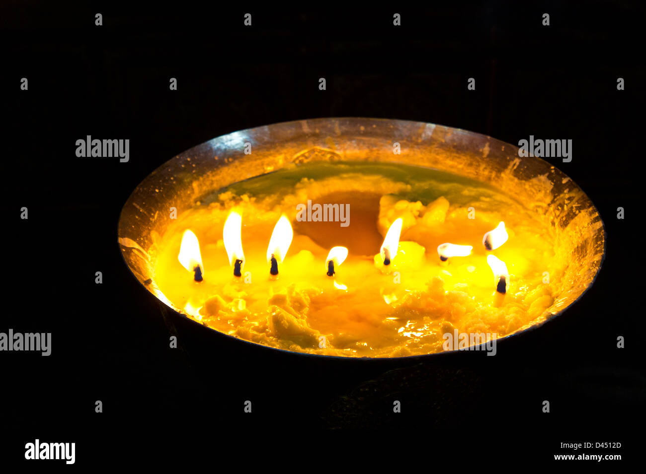 Yak butter lamp candle burning in Drepung monastery, Lhasa, Tibet Stock