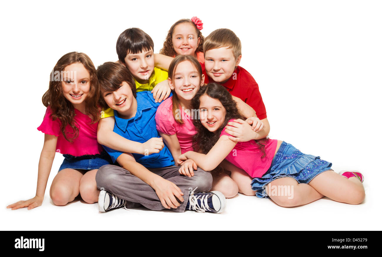 Group of 10 years old kids hugging, smiling, laughing, on white Stock Photo