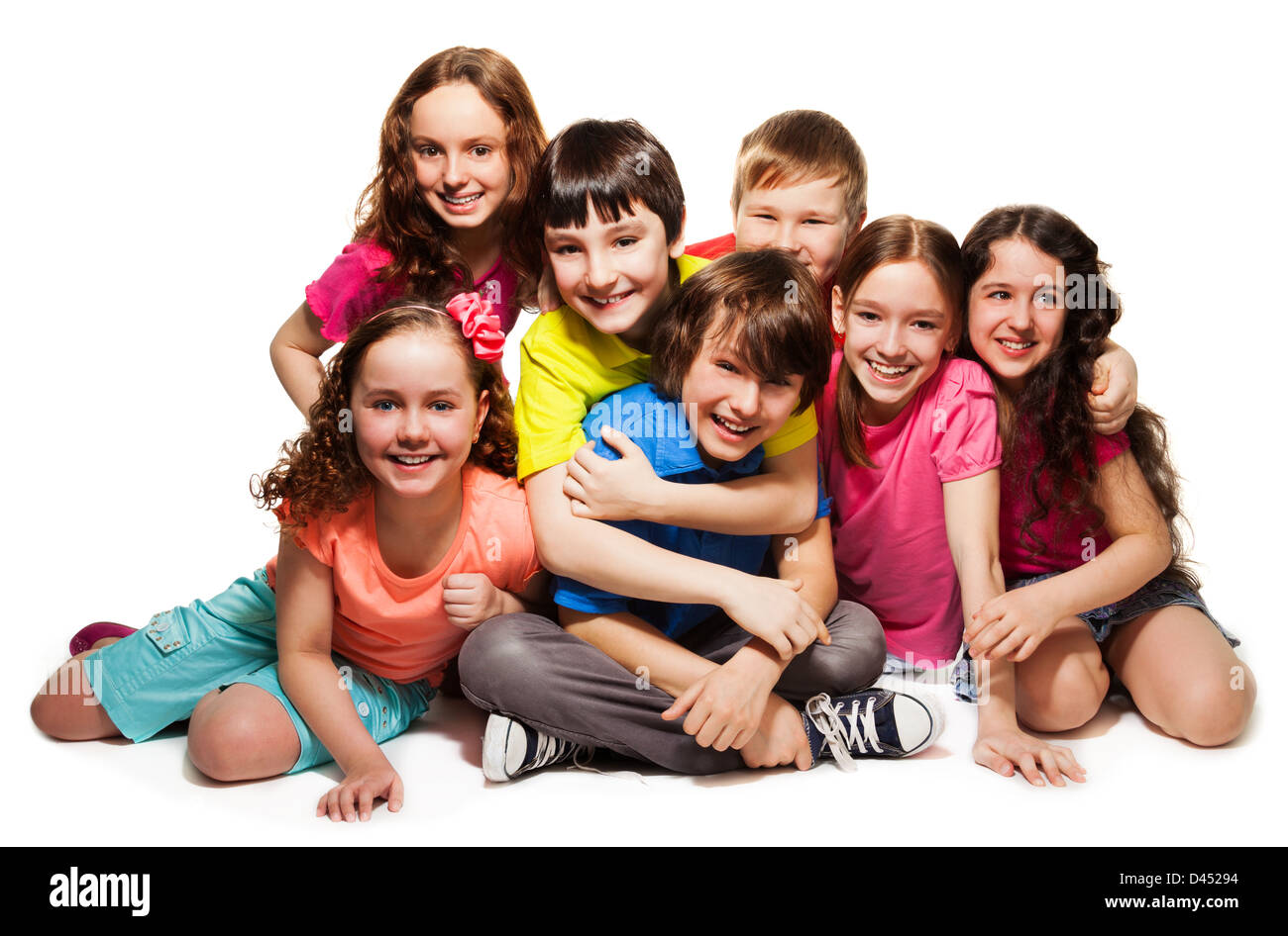 Group of happy hugging kids, laughing and smiling together in big group Stock Photo