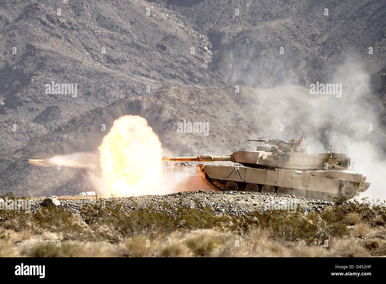 A US Army M1A2 Abrams tank fires a sabot round during annual gunnery qualifications February 17, 2013 in Twentynine Palms, CA. Stock Photo