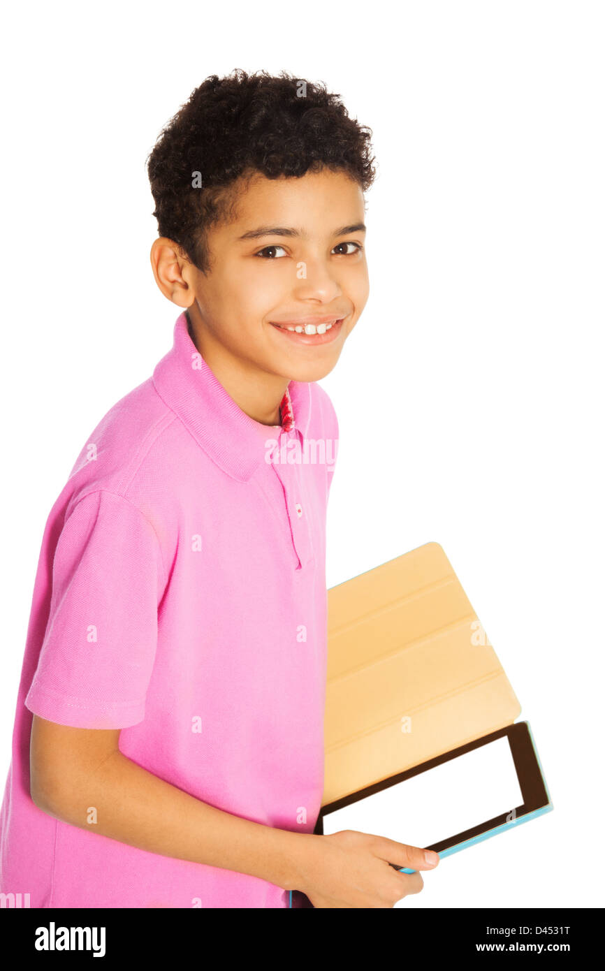 Happy and smiling 10 years old black boy standing with tablet computer, isolated on whtie Stock