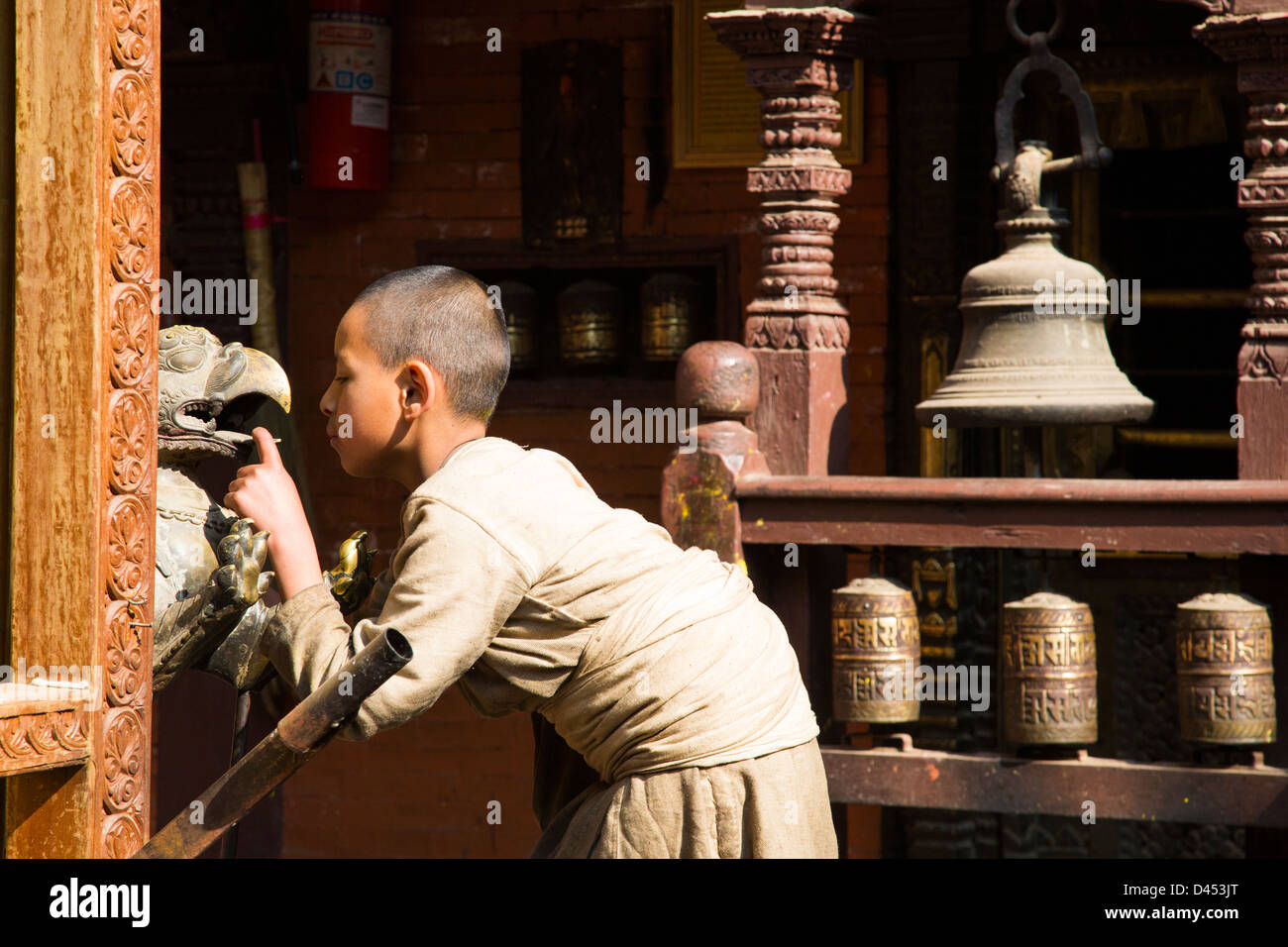 Young monk, Buddhist Golden Temple or Hiranya Varna Mahavihar, Patan (Lalitpur), Kathmandu, Nepal Stock Photo