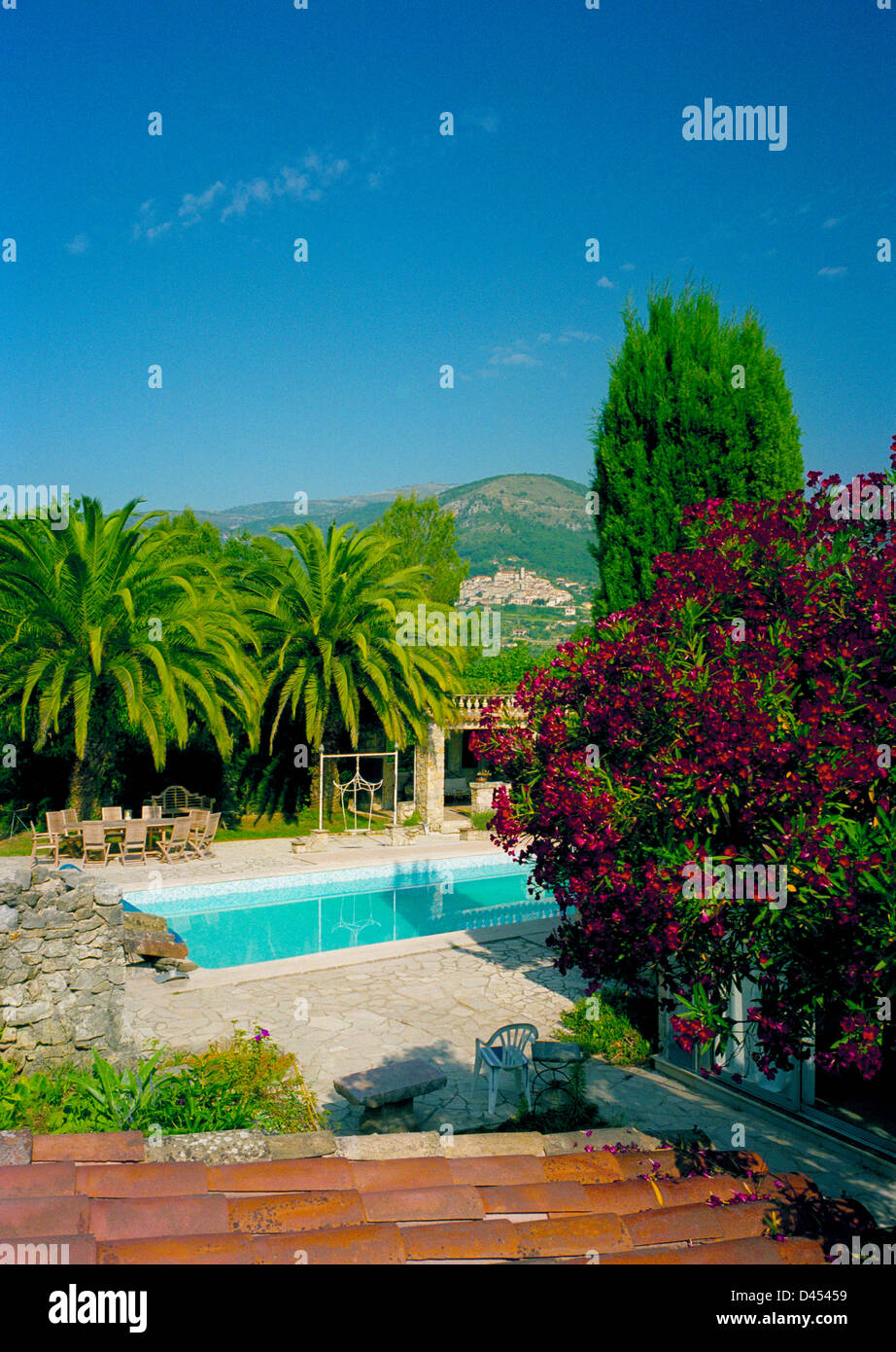 The garden of a large country house complete with swimming pool in the wooded valley of the Loup river, Provence, France Stock Photo