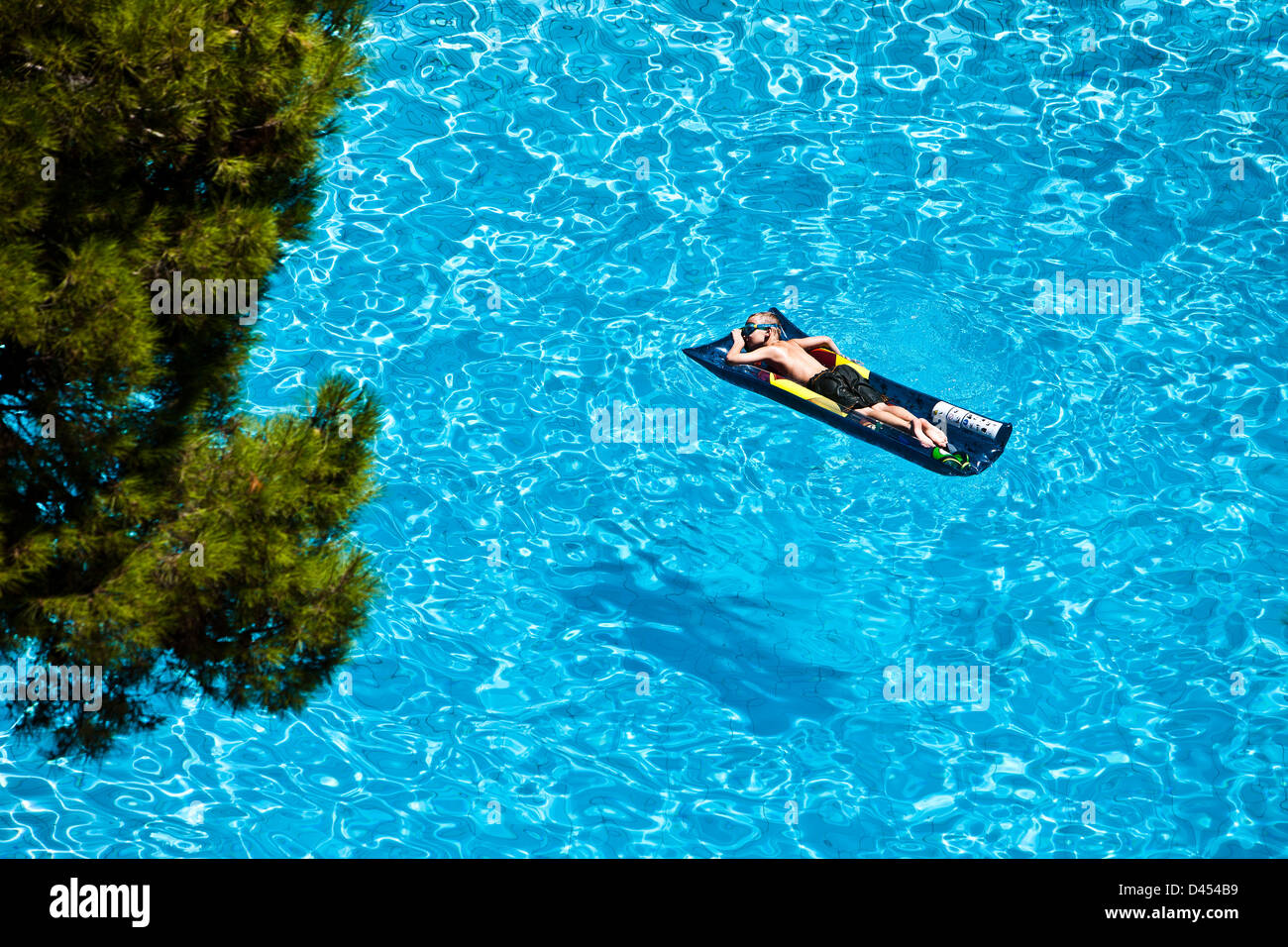 Scuba floating on inflatable air bed, Sardinia, Italy Stock Photo