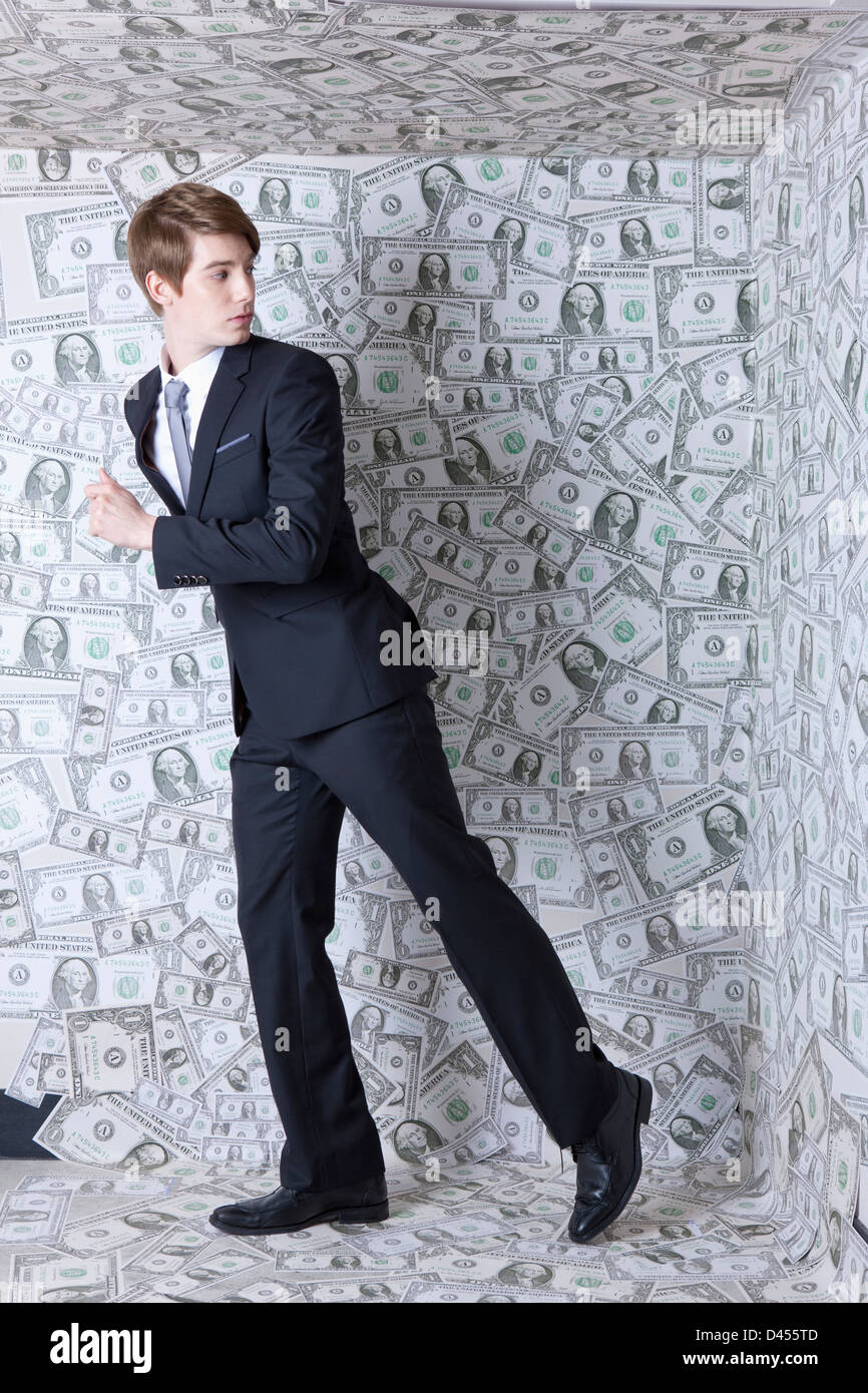 a businessman running away from a dollar room Stock Photo - Alamy