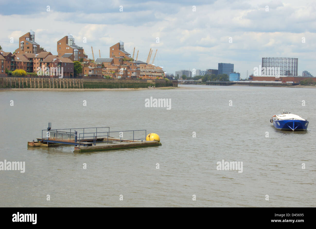 Waterfront buildings and mooring platform on the River Thames in London