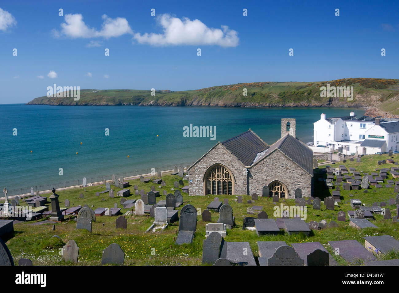St Hywyn's Church and churchyard with beach and bay behind Aberdaron Llŷn Peninsula Gwynedd North Wales UK Stock Photo