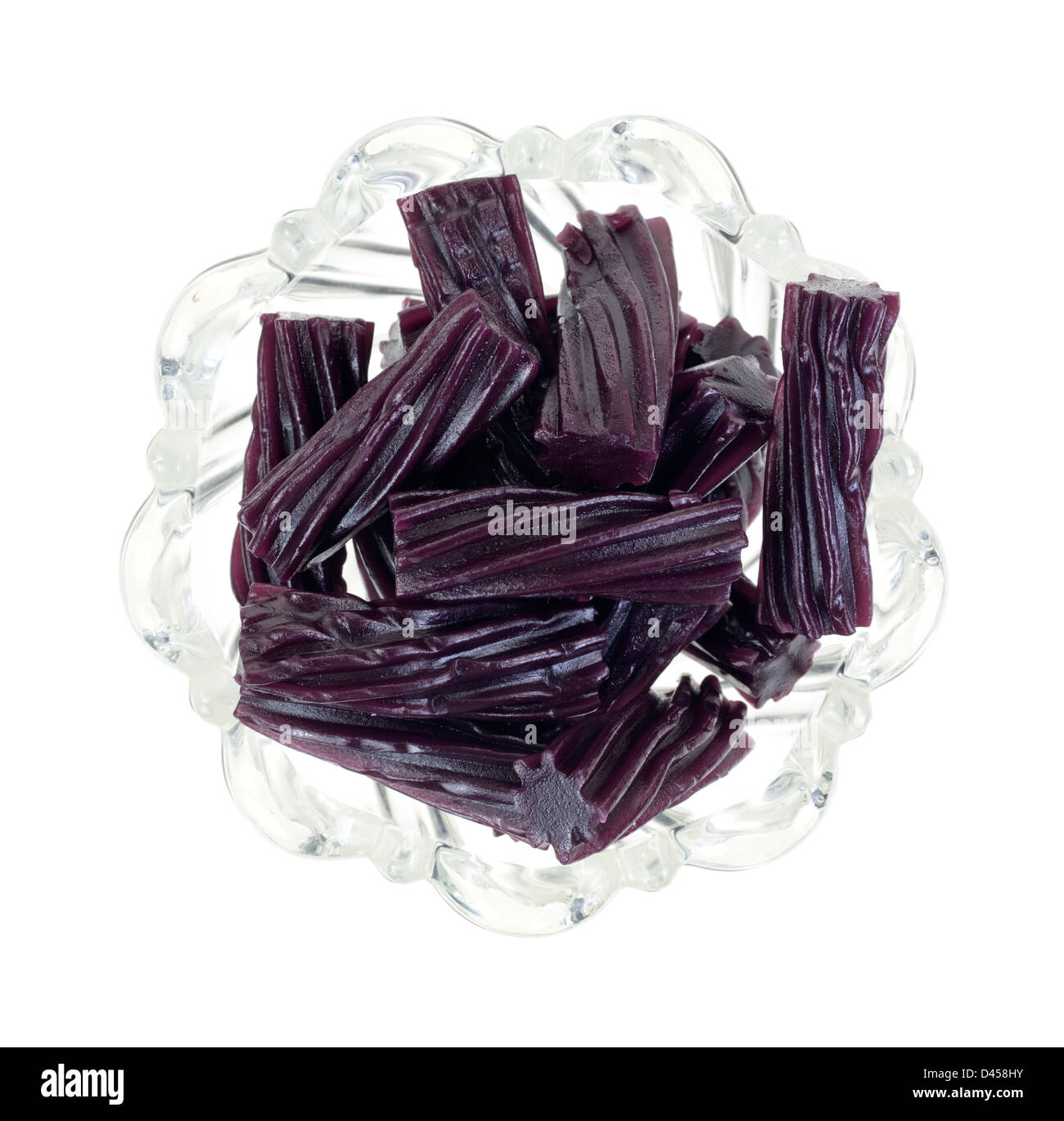 Top view of a small decorative bowl filled with pieces of black cherry licorice candy. Stock Photo