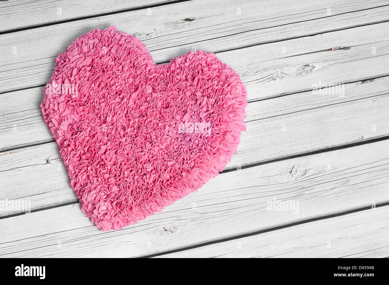 A large pink heart rug set on a white aged wooden floor Stock Photo Alamy