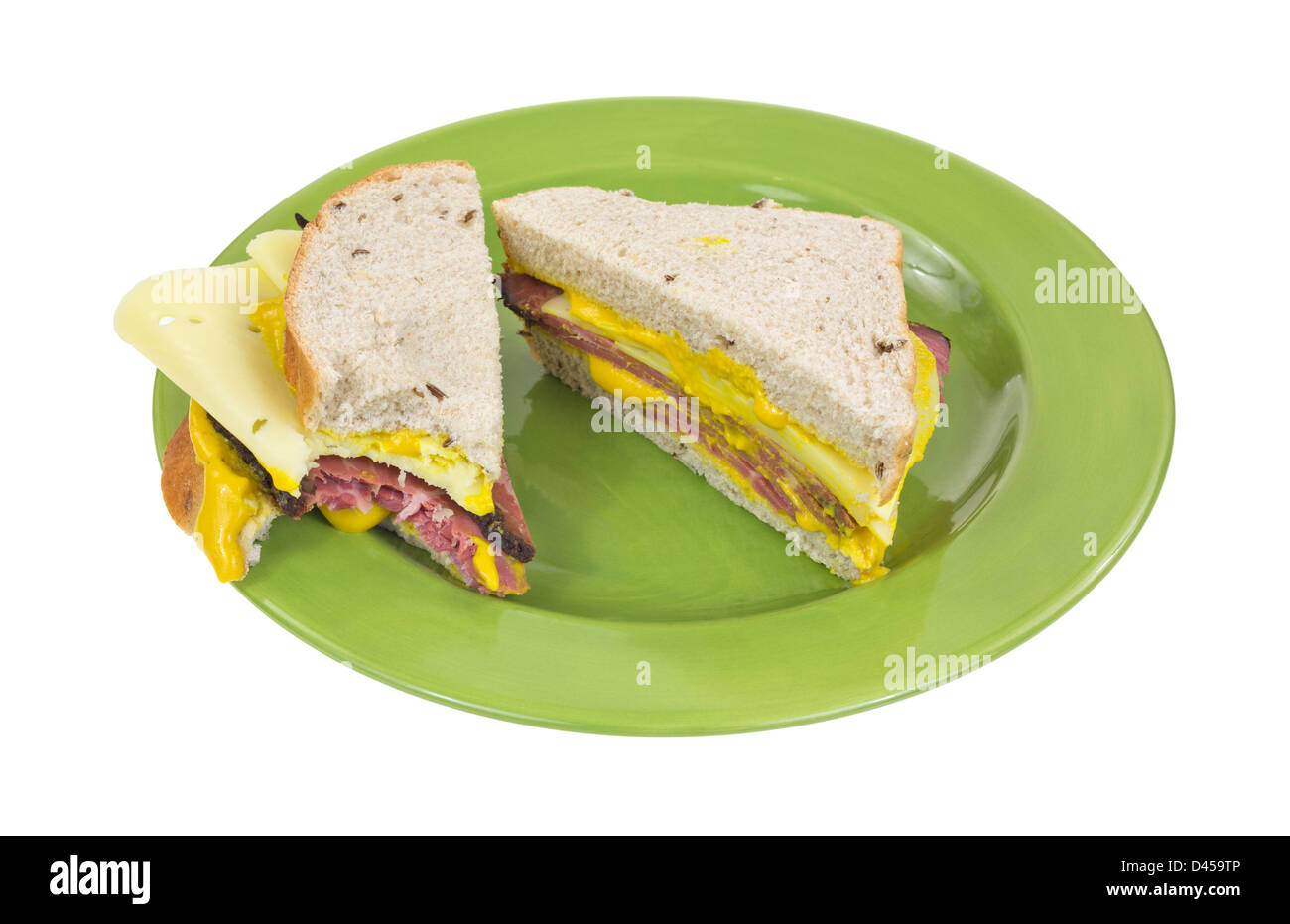 A sandwich of Swiss cheese prosciutto and mustard on seeded rye bread