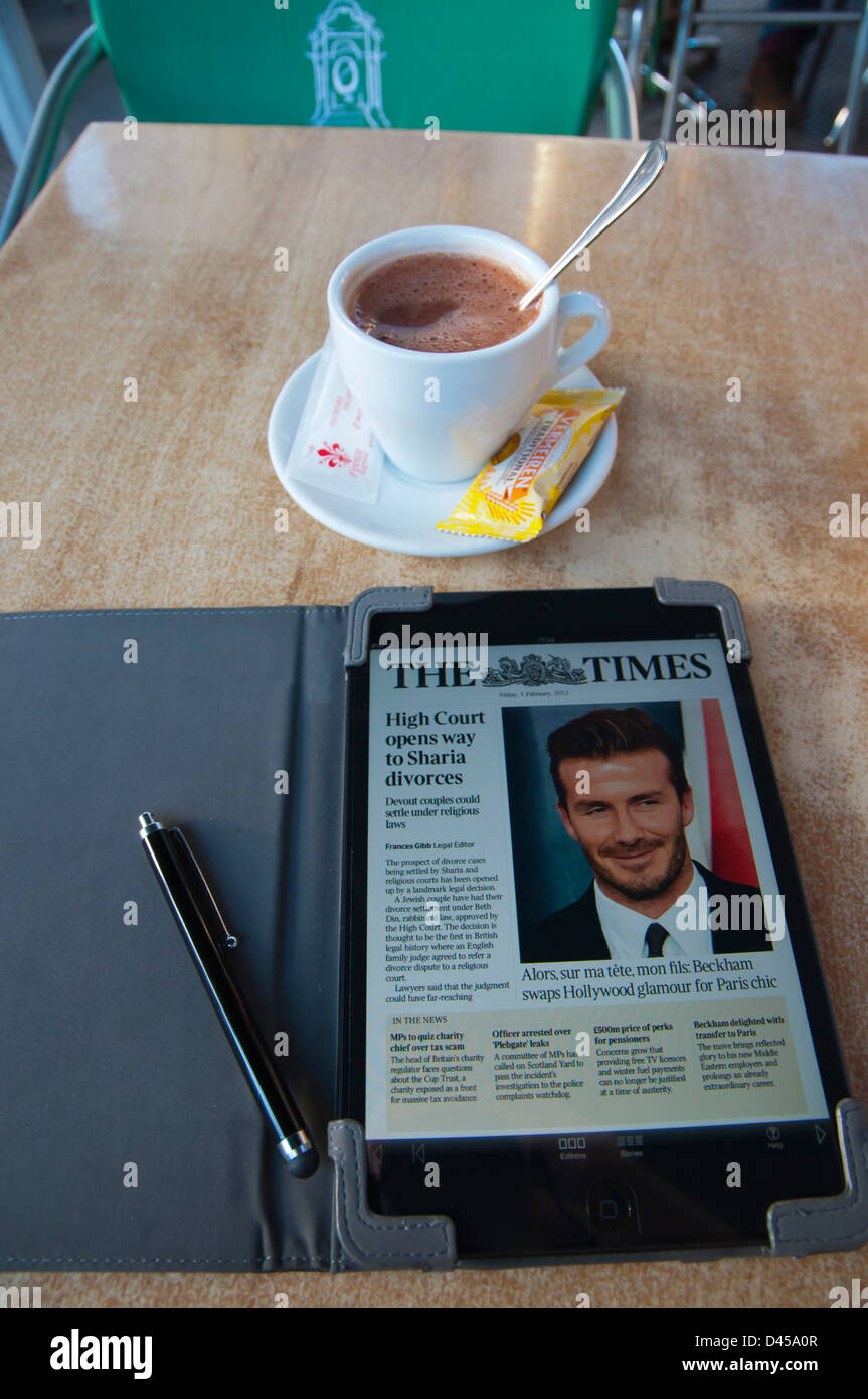 Hot drink and ipad mini tablet with the Times, Parque San Telmo, Triana, Las Palmas, Gran Canaria,Canary Islands Spain Stock Photo