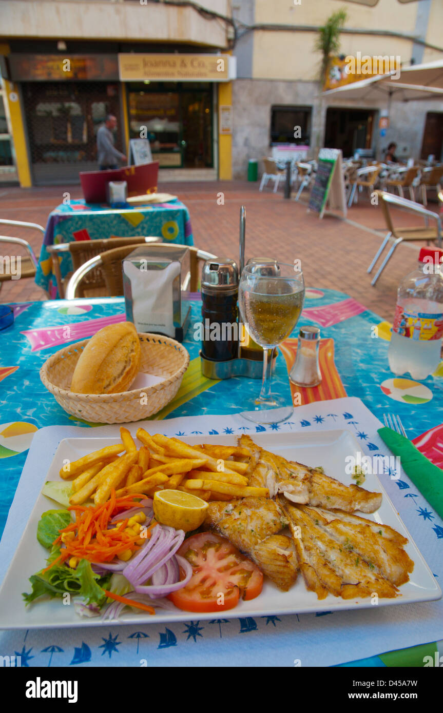 Menu del dia meal with fried white fish salad potato bread and drink near beach Las Palmas de Gran Canaria Spain Stock Photo