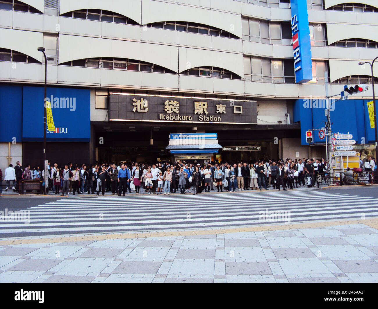 Japanese people waiting to cross the street in front of Ikebukuro station, Tokyo Stock Photo