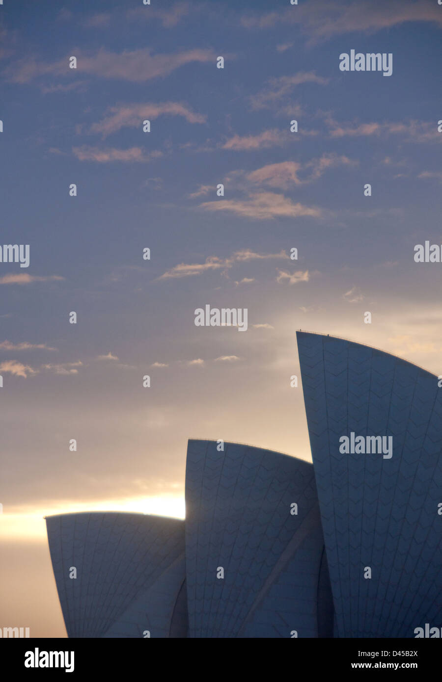 Sydney Opera House at dawn silhouetted with 'sails' backlit with glow ...