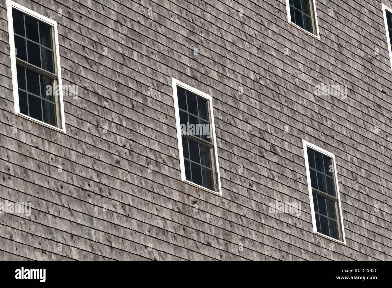 Multiple exterior windows set against cedar shingles. Stock Photo
