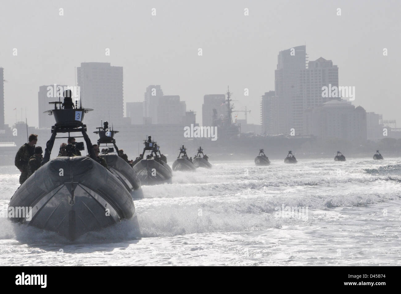 Rigid-hull inflatable boats carry Special Boat Team 12 Sailors and guests through San Diego Bay to an at-sea change of command. Stock Photo