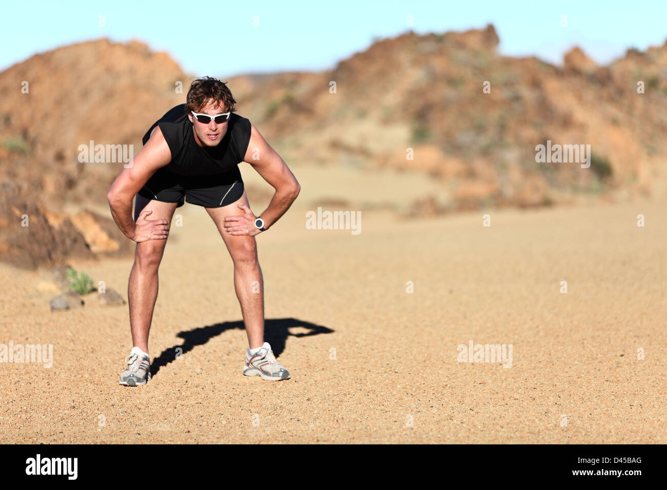 Full length of fit young Caucasian male runner taking a break from run