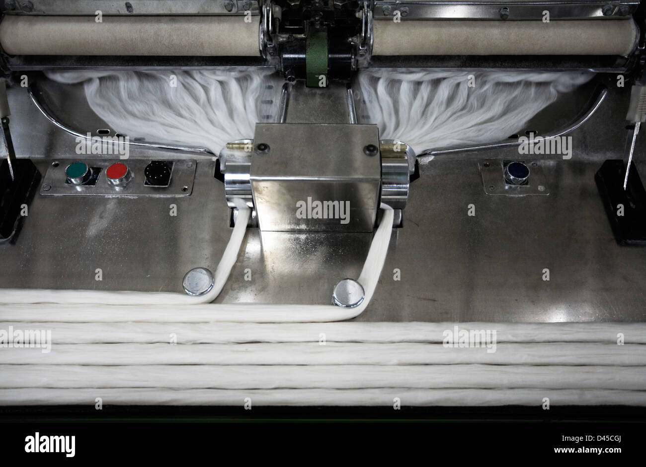 Cotton going into a machine for spinning Stock Photo - Alamy