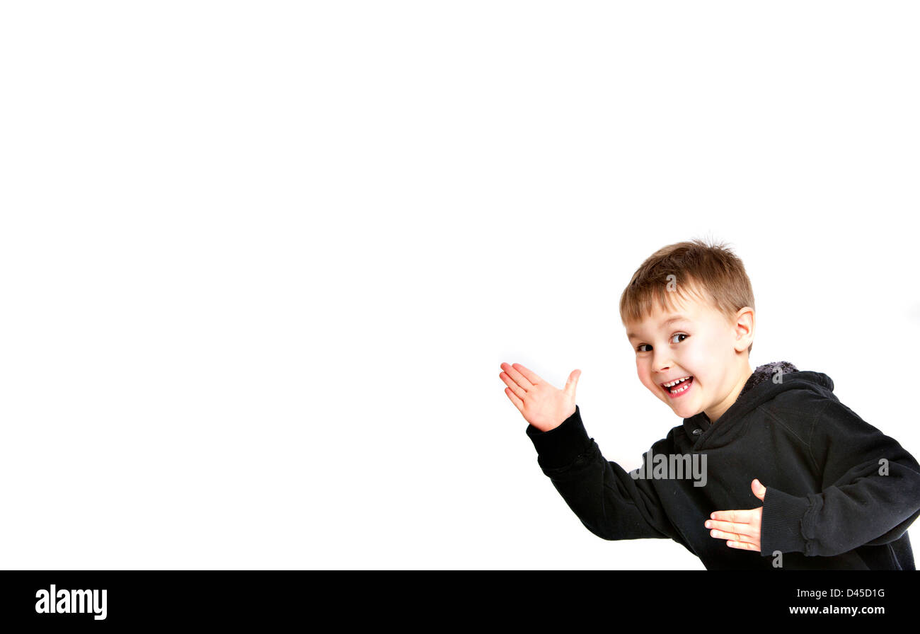 Five year old boy in a black hoodie sweatshirt with sallow skin brown hair and brown eyes against a white background. funny kid. Stock Photo