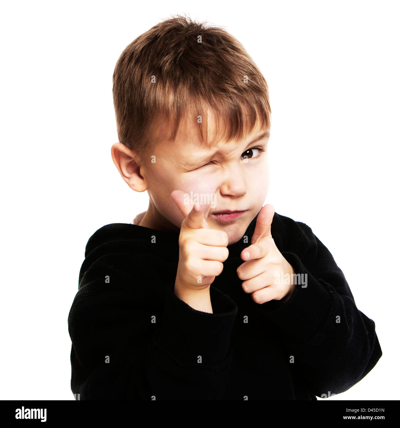 Five year old boy in a black hoodie sweatshirt with sallow skin brown hair and brown eyes against a white background. Stock Photo