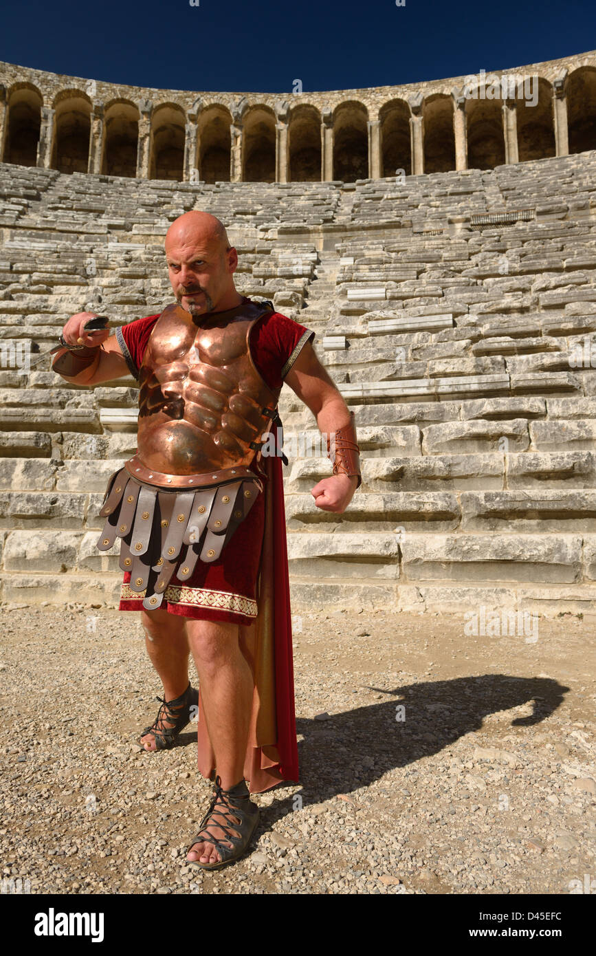 Roman Gladiator with sword in sun on stage at the ancient Aspendos theatre Turkey Stock Photo