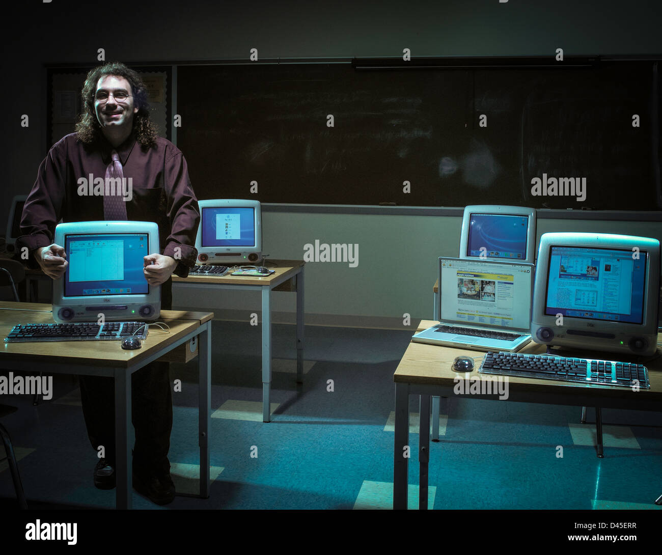 Teacher in computer lab. Stock Photo