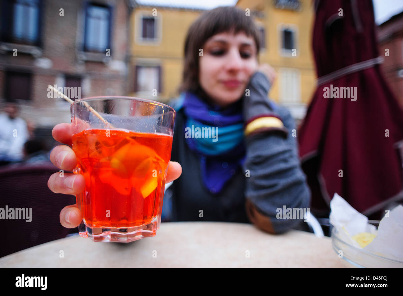 A young woman drinking an Aperol Spritz in Venice, Italy. Stock Photo