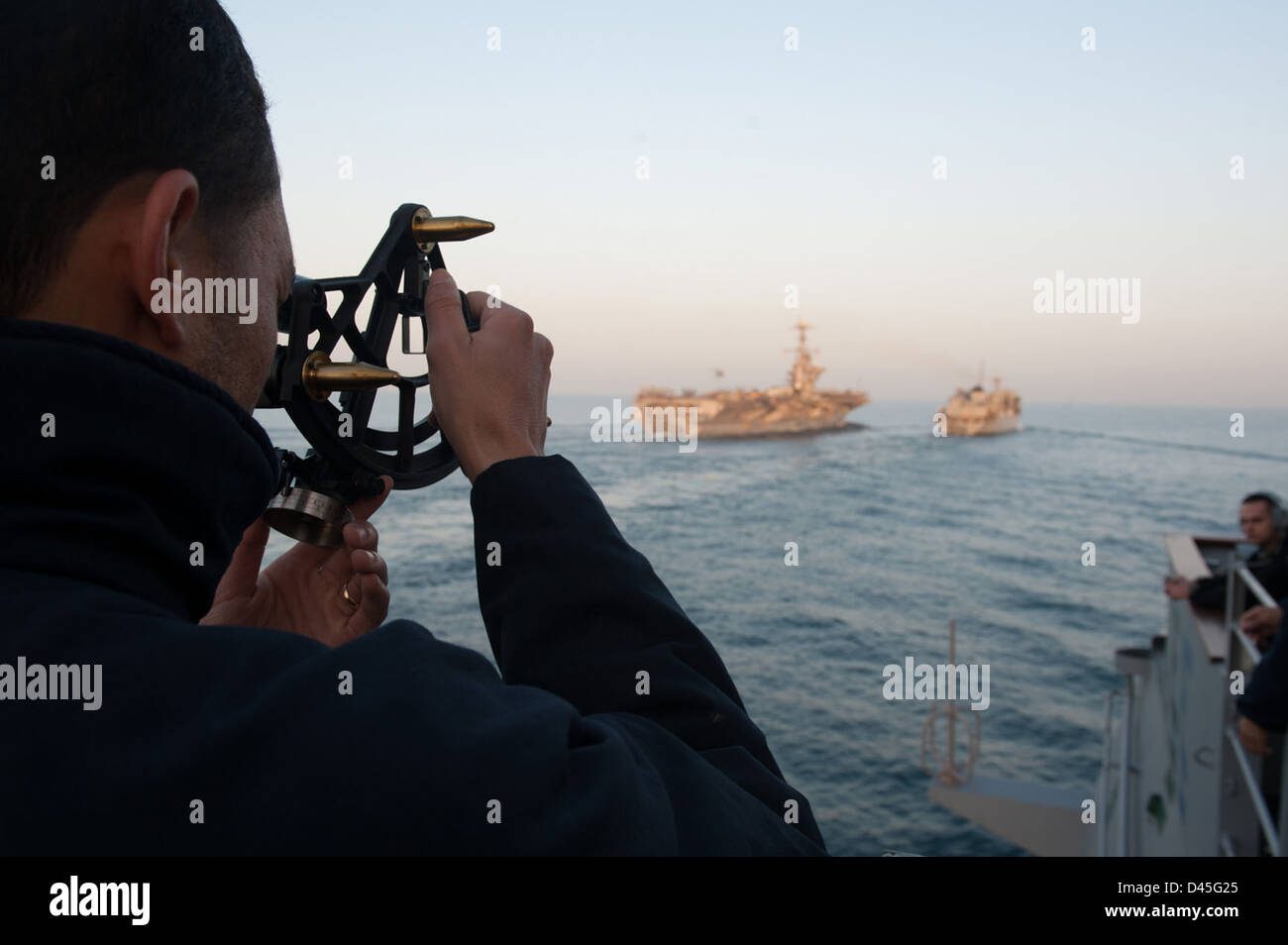 A Sailor measures distance at sea as part of navigational operations in ...