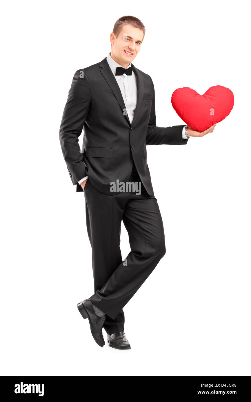 Full length portrait of a young man wearing black suit and holding a ...