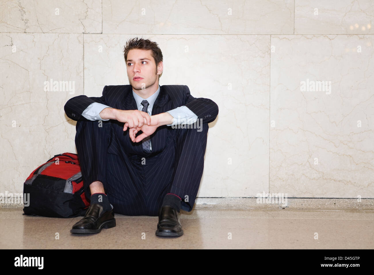 a young office worker waiting for his train to arrive at grand central train station in new york Stock Photo