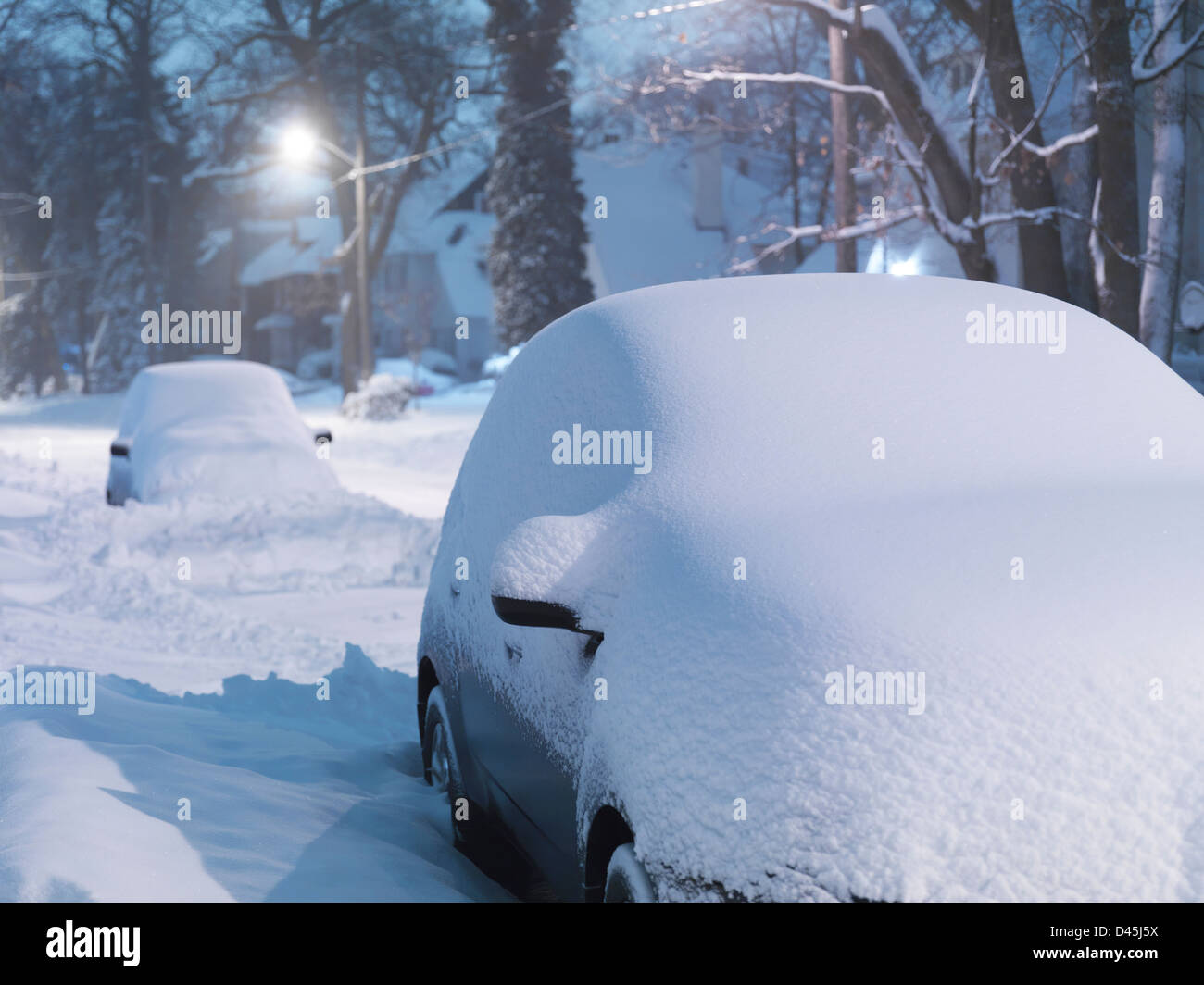 Covered with snow cars on Toronto city street after a snow storm in winter 2013. Wintertime scenery, Toronto, Ontario, Canada. Stock Photo