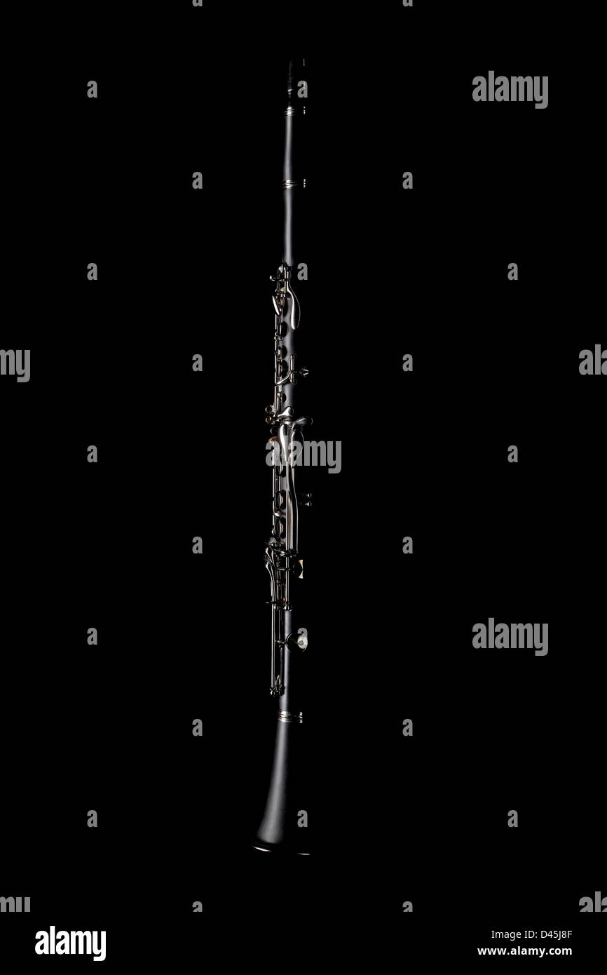 A clarinet with dramatic side lighting on a black background - Exclusively on Alamy Stock Photo