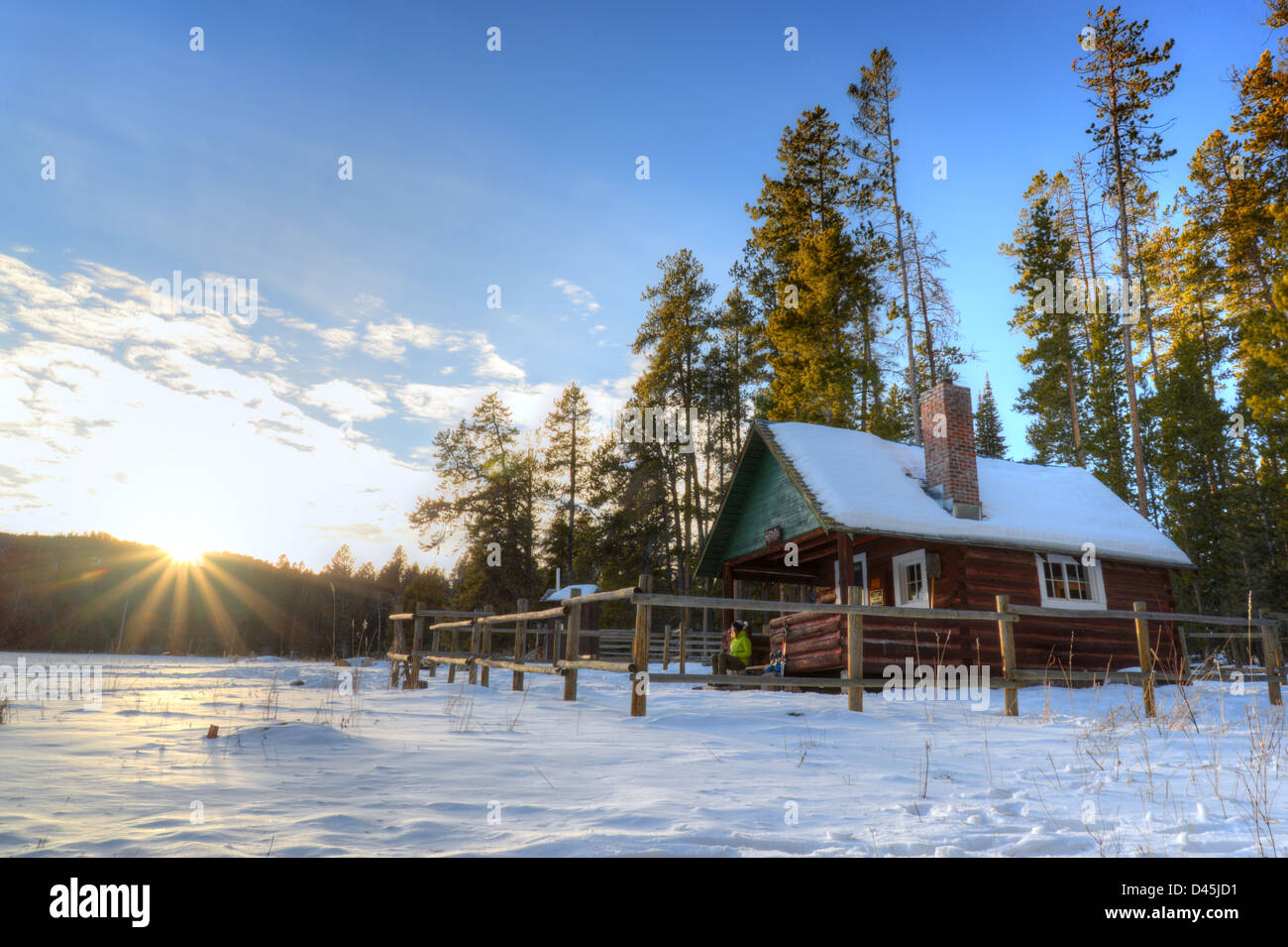 The Sun Setting Over A Forest Service Cabin In The Gallatin