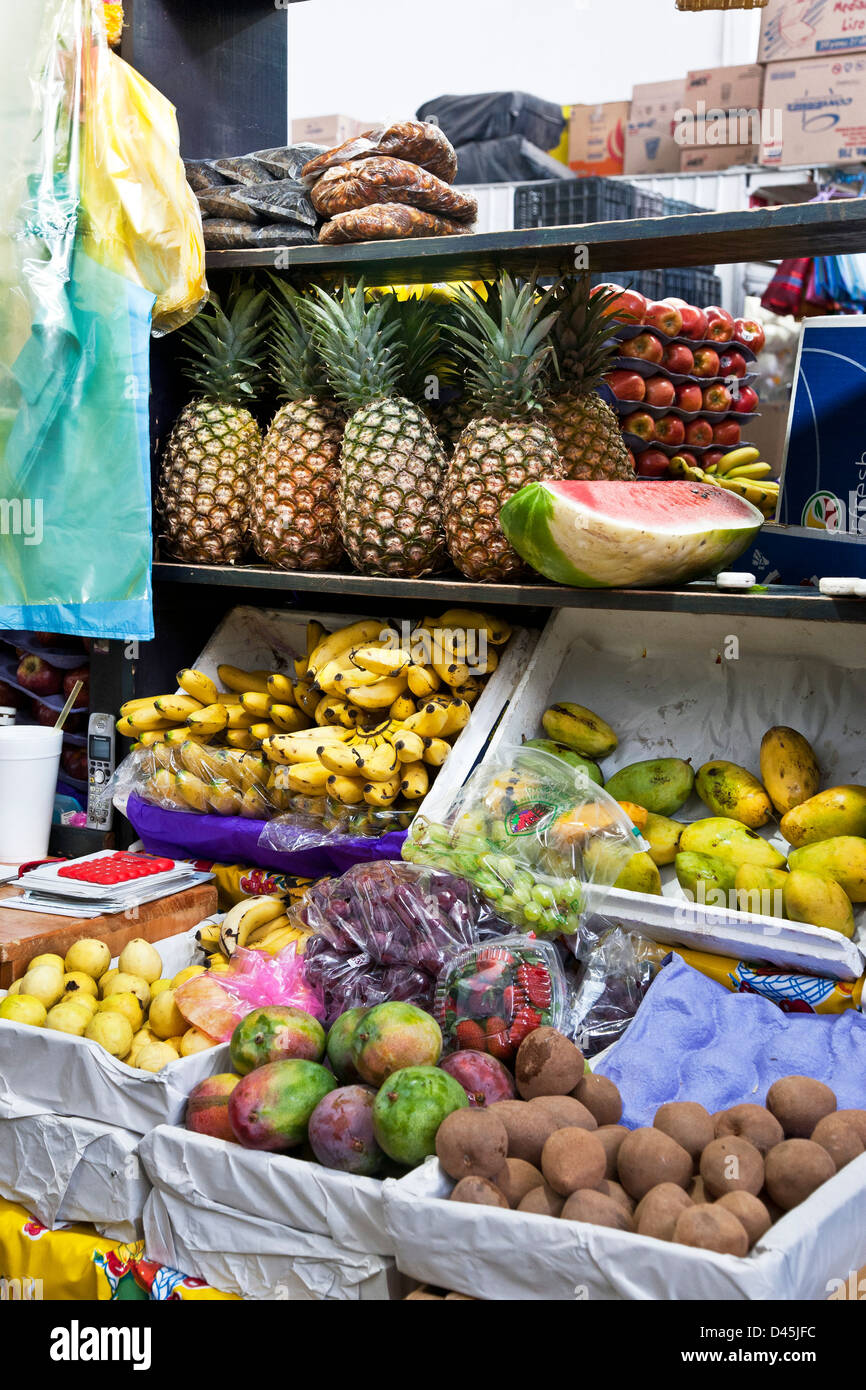 pineapple watermelon bananas mangoes grapes strawberries apples fruit displayed for sale in mercado La Merced market Oaxaca Stock Photo