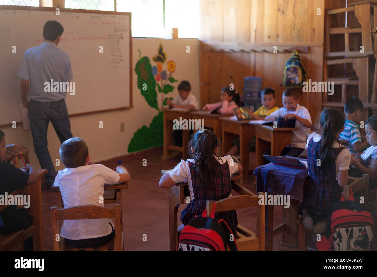 Students pay attention to the teacher in a classroom in the colonial town of Suchitoto in El Salvador Stock Photo