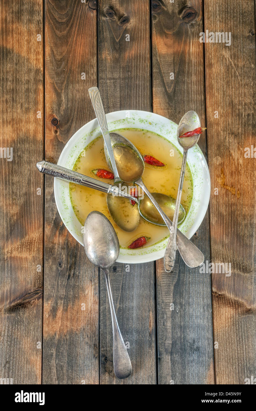 soup plate with hot chillies and five spoons Stock Photo