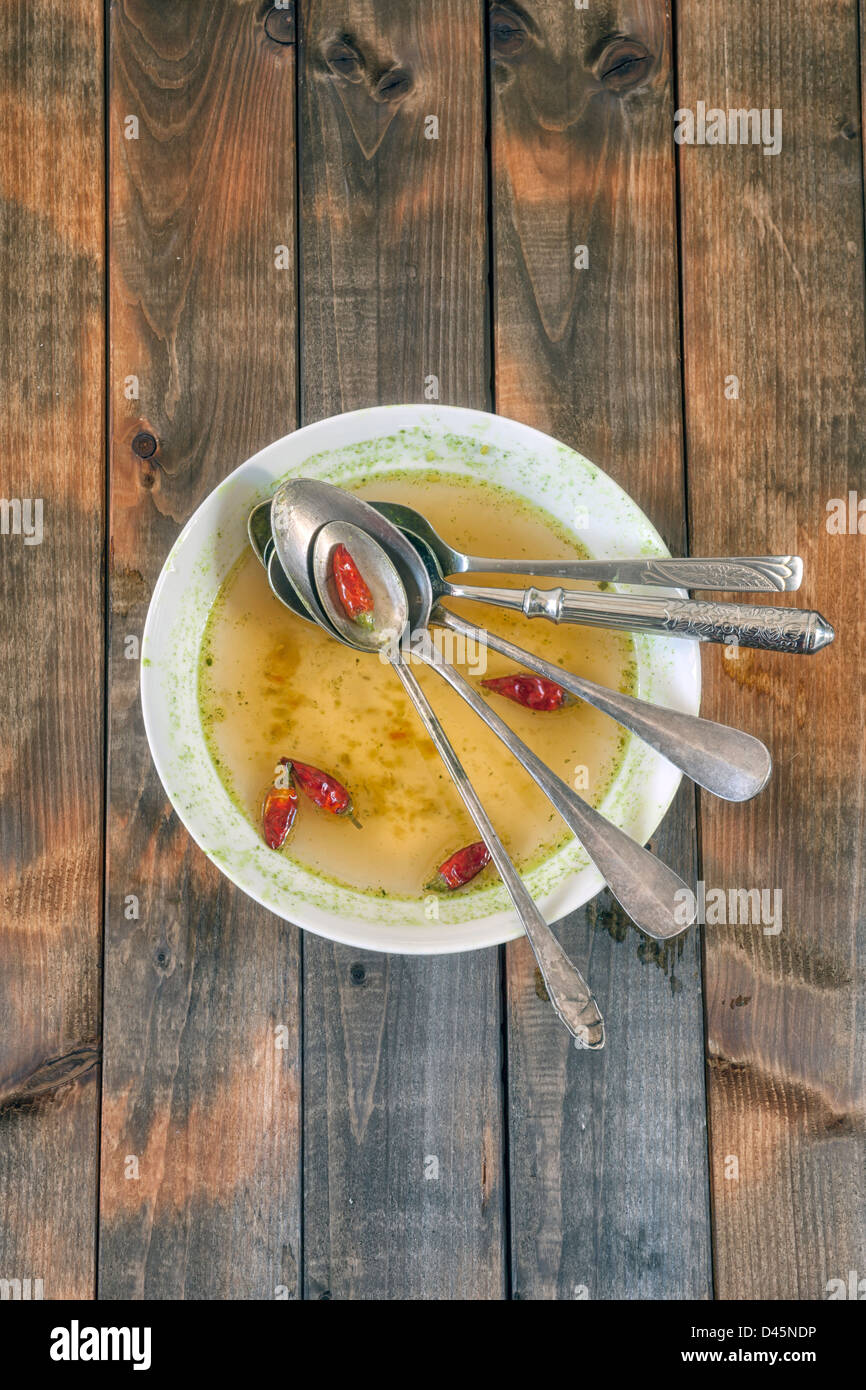 soup plate with hot chillies and five spoons Stock Photo