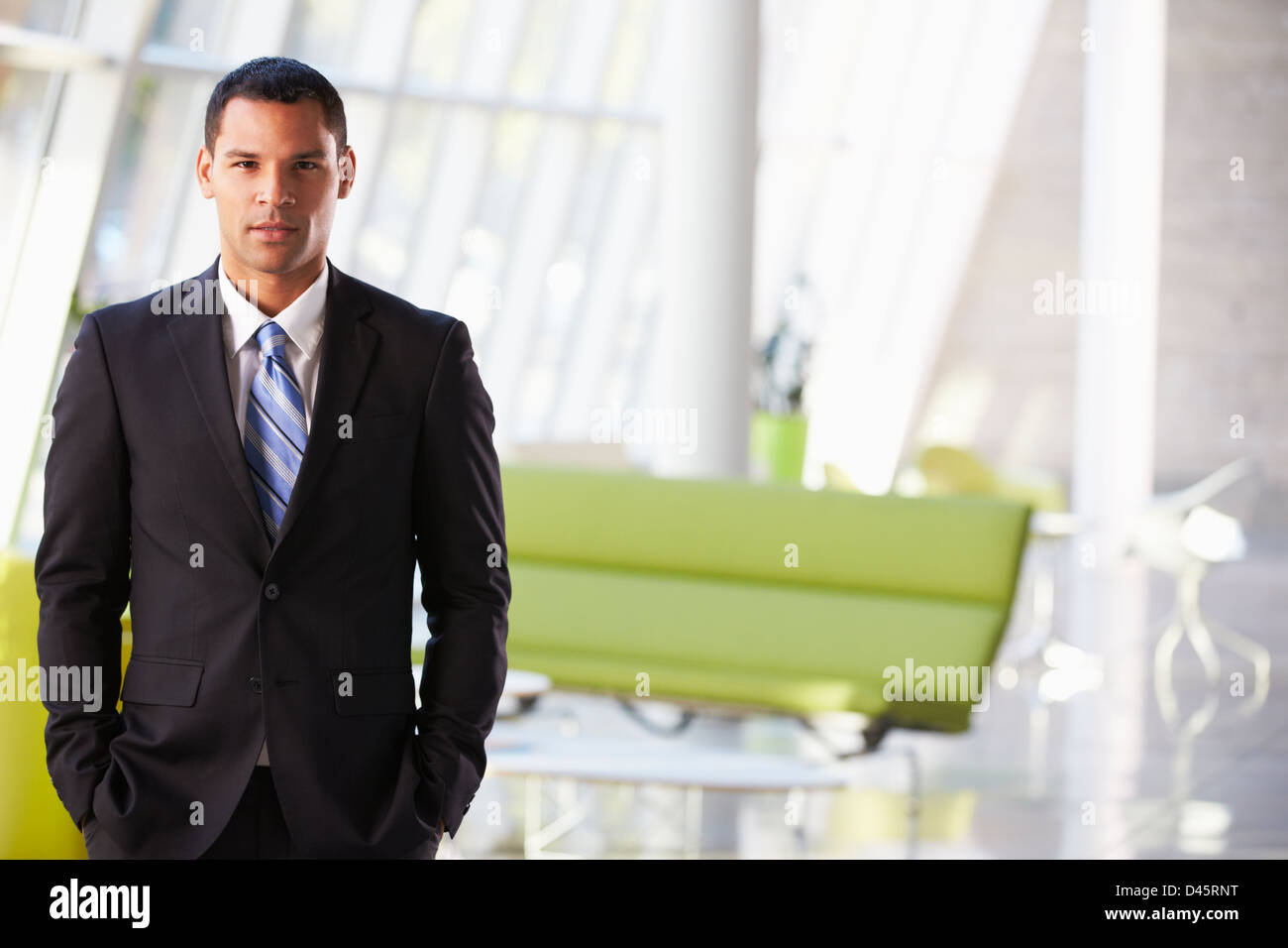 Portrait Of Businessman Standing Modern Office Reception Stock Photo