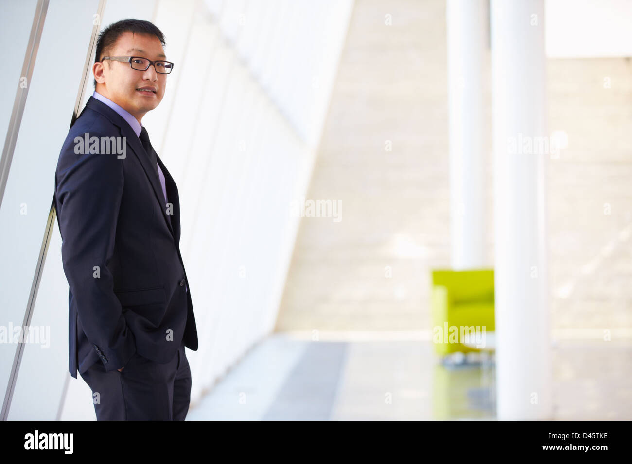 Portrait Of Businessman Standing Modern Office Reception Stock Photo