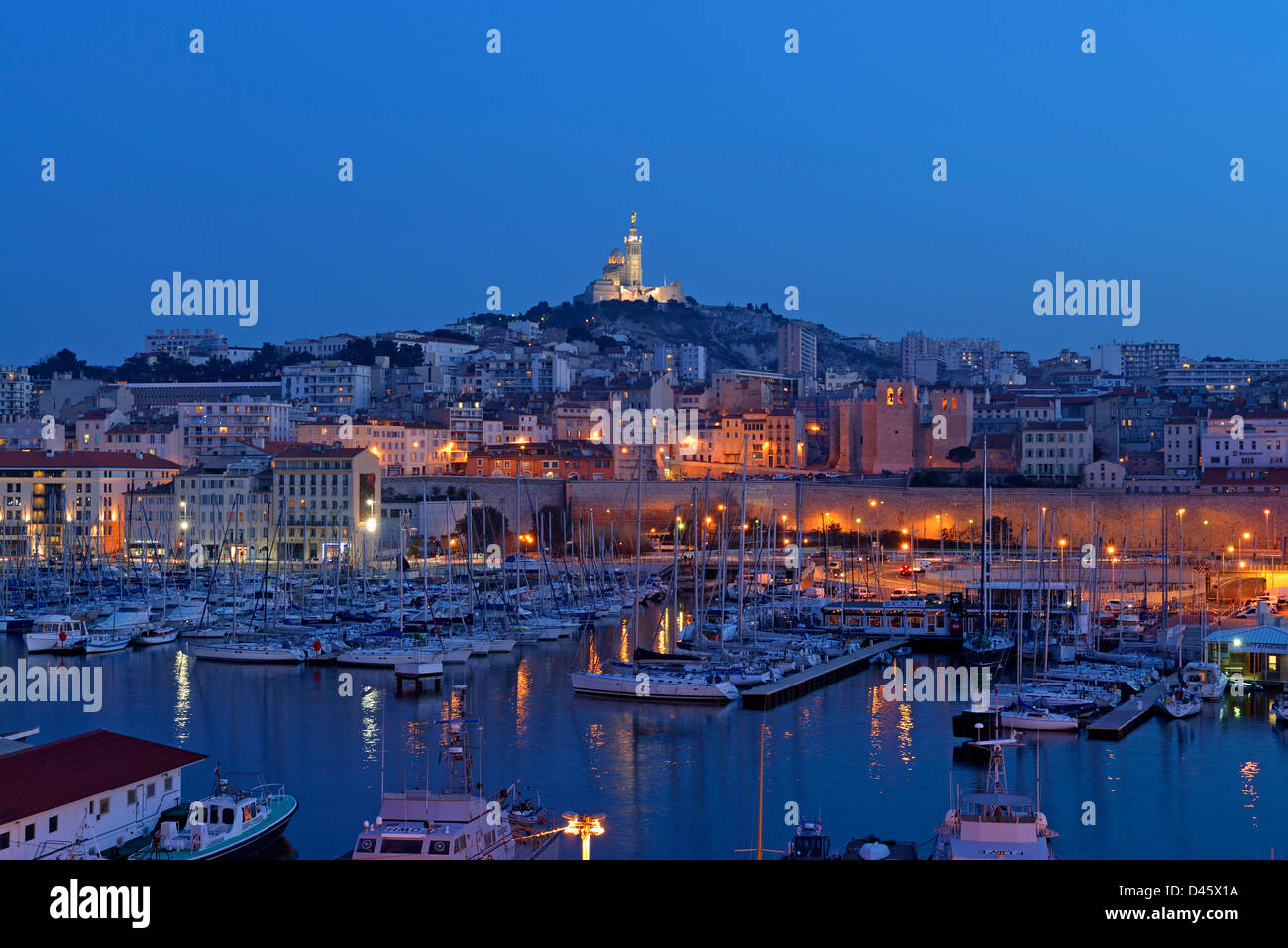 Boats in the marina of the Vieux-Port with Notre Dame de la Garde in the background, Marseille, France. Stock Photo